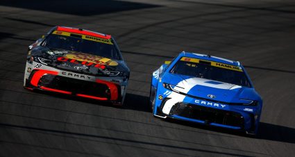 Chase Briscoe, driver of the No. 19 Bass Pro Shops Toyota, and Denny Hamlin, driver of the No. 11 Progressive Toyota, race during the NASCAR Cup Series Enjoy Illinois 300 at WWT Raceway on Sept. 7, 2025 in Madison, Illinois.
