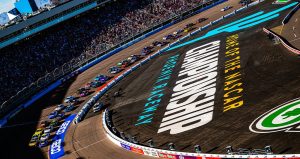 Cars race around Phoenix Raceway.