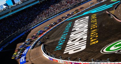 Cars race around Phoenix Raceway.