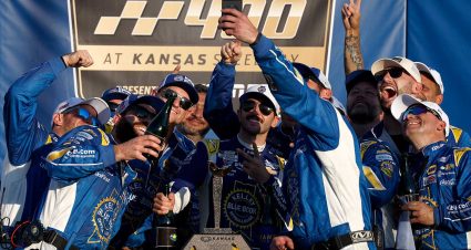 Chase Elliott and Kansas Speedway president Pat Warren eat ribs in Victory Lane