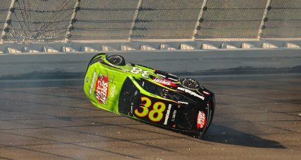 Zane Smith No. 38 Front Row Motorsports Ford on its side at Kansas Speedway.
