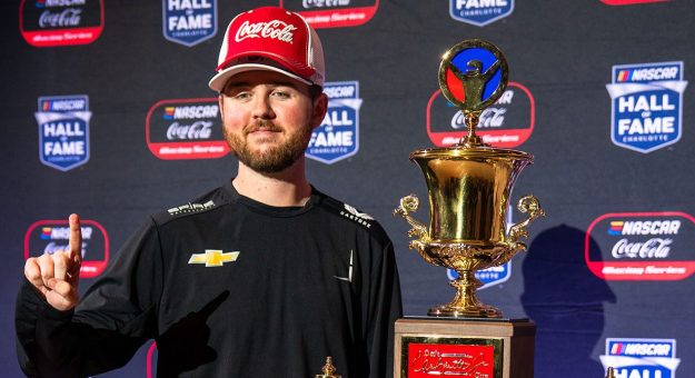 steven wilson poses with Coca cola iracing series trophy