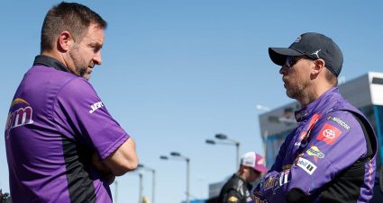 Denny Hamlin and Chris Gayle talk things over in the Xfinity Series garage at Auto Club Speedway