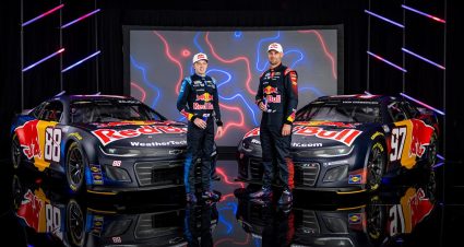 Connor Zilisch and Shane van Gisbergen stand next to their Nos. 88 and 97 Trackhouse Racing cars displaying Red Bull colors for 2026.
