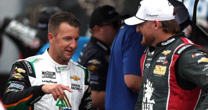 AJ Allmendinger speaks with Kaulig Racing teammate Ty Dillon before a NASCAR Cup Series event.