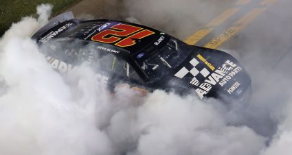 Ryan Blaney performs a burnout in a Ford Mustang Dark Horse.