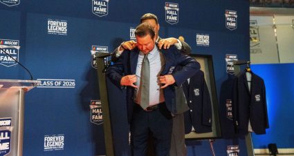 Kurt Busch receives his NASCAR Hall of Fame jacket from NASCAR President Steve O'Donnell.