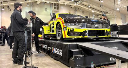 Cup Series cars line up after inspection in the Winston-Salem Fairgrounds events center