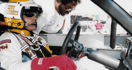 Team owner Rick Hendrick is suited up as he speaks with veteran crew chief Harry Hyde during the 1980s