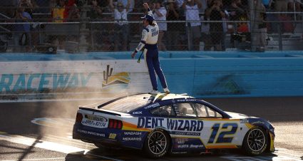 Ryan Blaney celebrates his win on March 8, 2026 at Phoenix Raceway by standing on top of his car and saluting the fans.