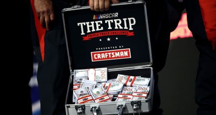 Tyler Ankrum poses for a photo with the Triple Truck Challenge check after winning a NASCAR Craftsman Truck Series race at Rockingham Speedway.