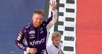 Tyler Reddick, driver of the No. 45 Xfinity Toyota, celebrates with his son, Beau Reddick after winning the NASCAR Cup Series Goodyear 400 at Darlington Raceway on March 22, 2026 in Darlington, South Carolina.