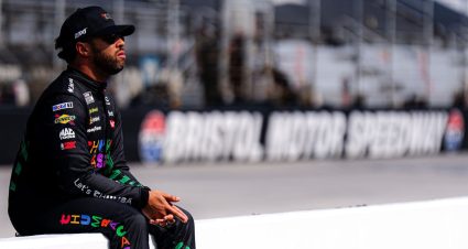 Bubba Wallace sits on pit wall at Bristol before NASCAR Cup Series action.