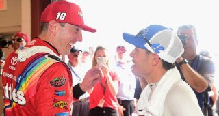 Kyle Busch pretends to wipe tears from eyes after winning the NASCAR Cup Series race in 2018 at Chicagoland Speedway.