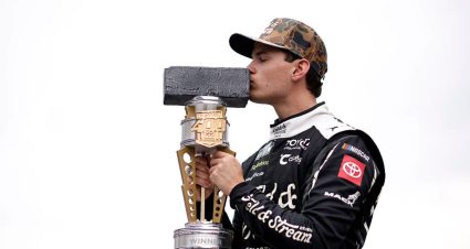 Corey Heim kisses a trophy.