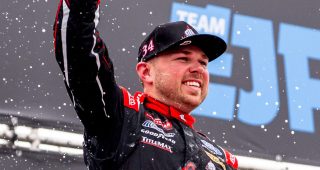 layne riggs celebrates in victory lane