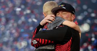 tyler reddick hugs and celebrates with his son