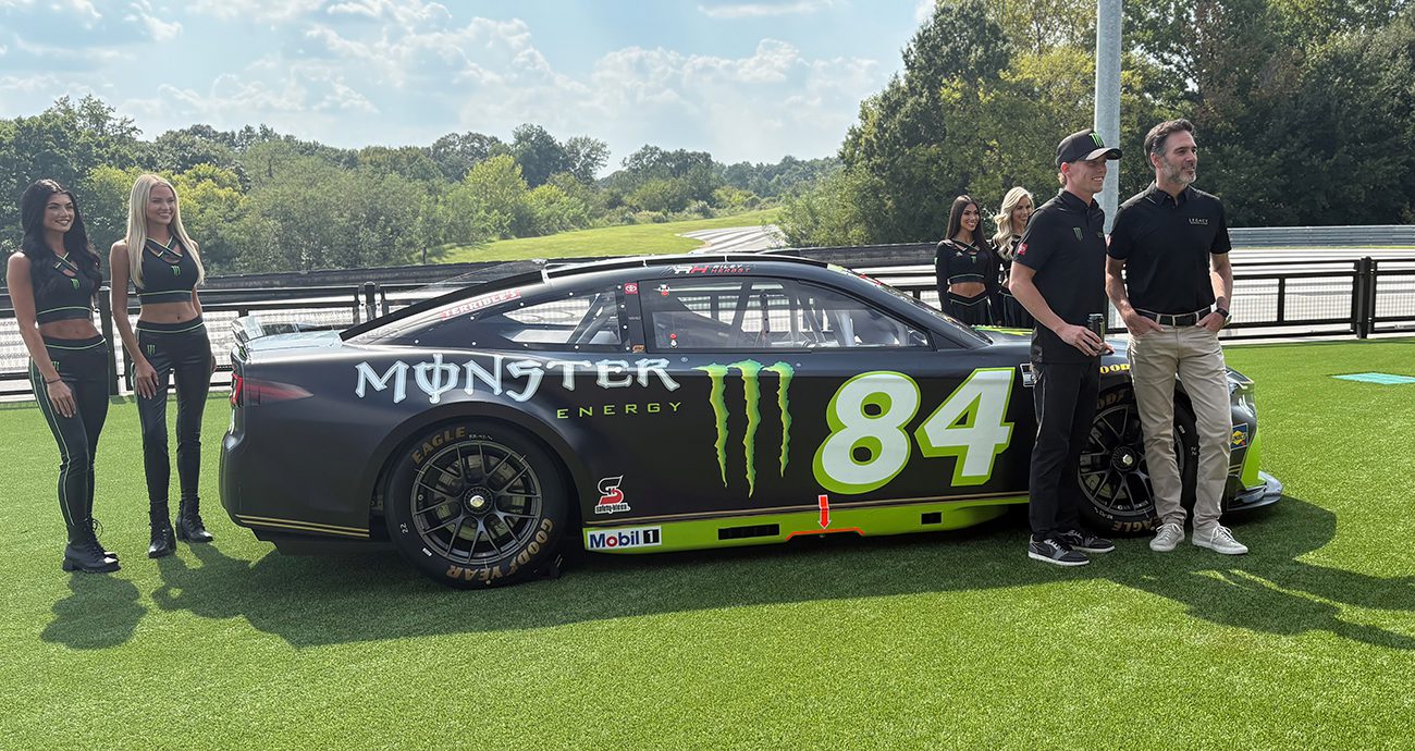 Riley Herbst and Jimmie Johnson pose by the No. 84 Toyota.