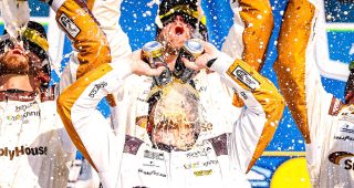 tyler reddick celebrates in victory lane at kansas